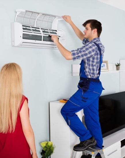 A person servicing an AC