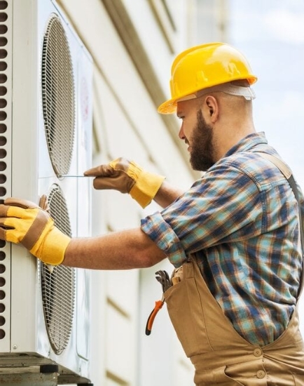 A person installing a new AC